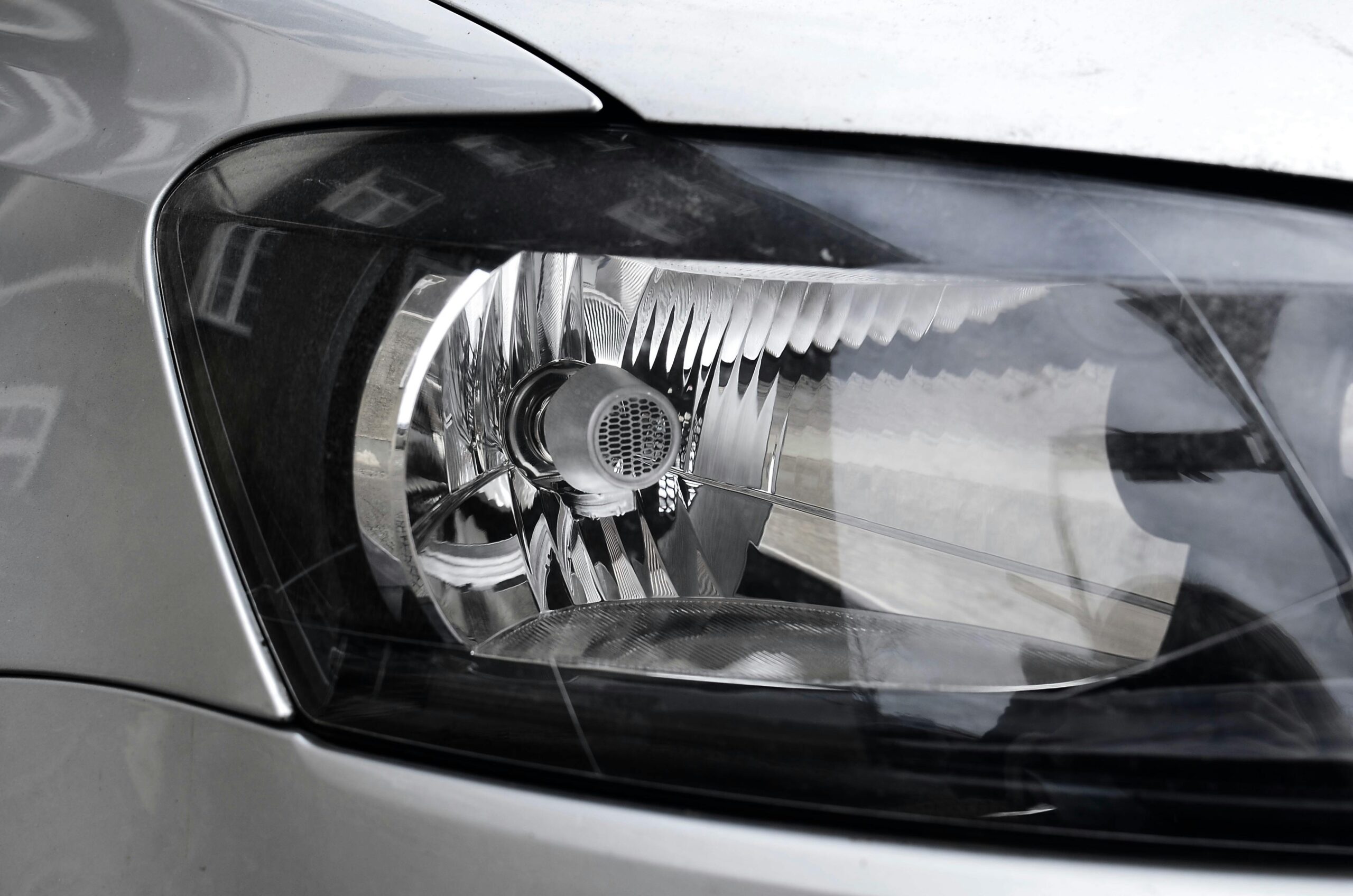 Detailed view of a chrome car headlight with reflective elements.